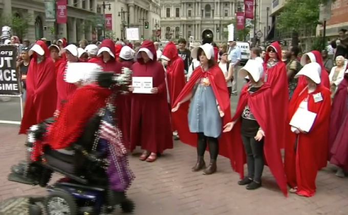 ผู้ประท้วงสวมชุดแดงต่อต้าน “ไมค์ เพนซ์”